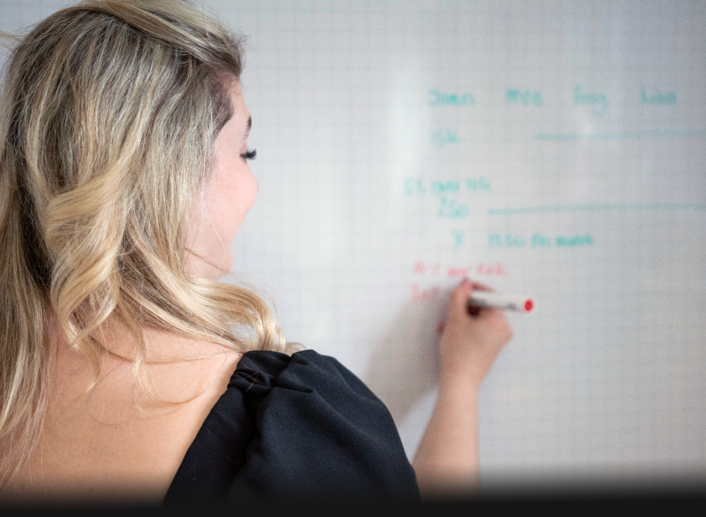 Employee writing on whiteboard